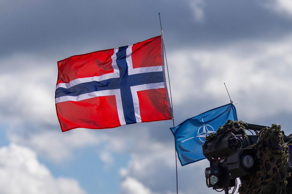 Norway's, left, and NATO's flags are seen during a military exercise 'Iron Wolf 2025-I' at the Gaiziunai Training Area, Lithuania, on May 16, 2025. (AP Photo/Mindaugas Kulbis, File)
